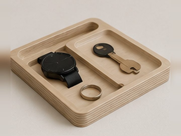 Design visualisation of a birch plywood valet tray holding a watch, key and ring.