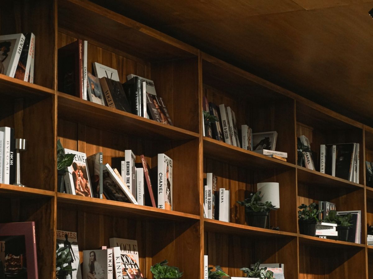 A warm timber wall of fitted shelving in a restaurant.